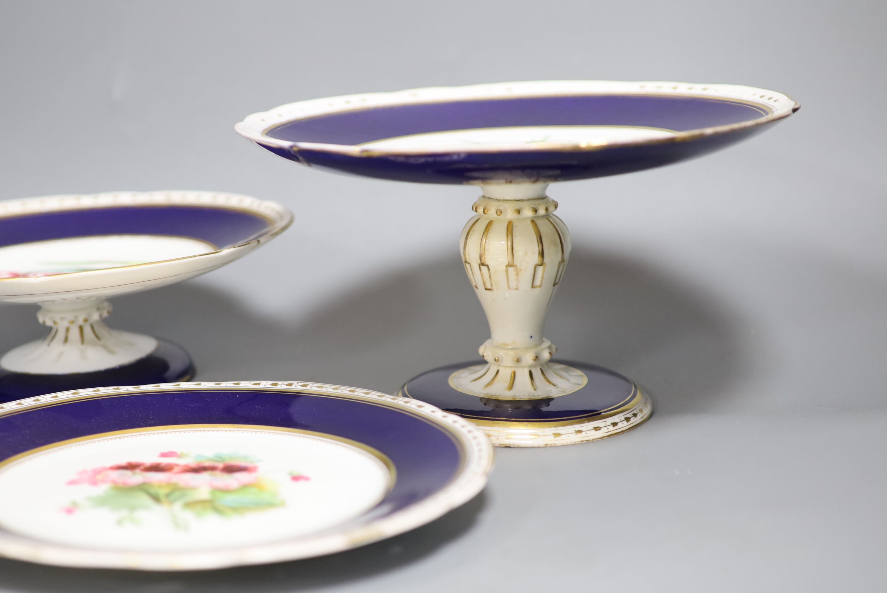 A Victorian porcelain flower painted dessert service, comprising eighteen plates and six cake stands